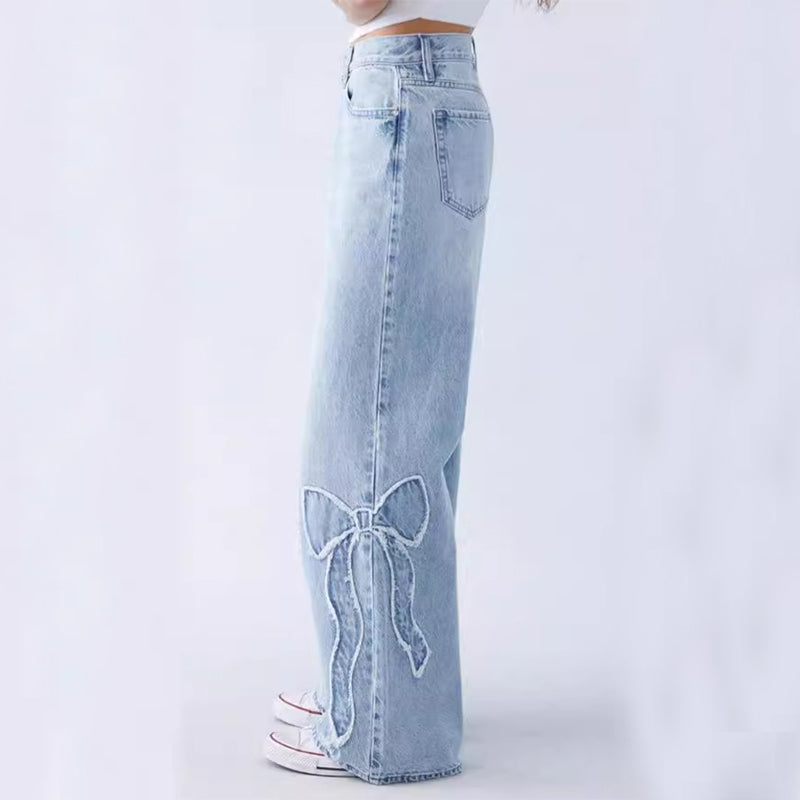 Wiga - pantalon en denim avec broderie de nœuds