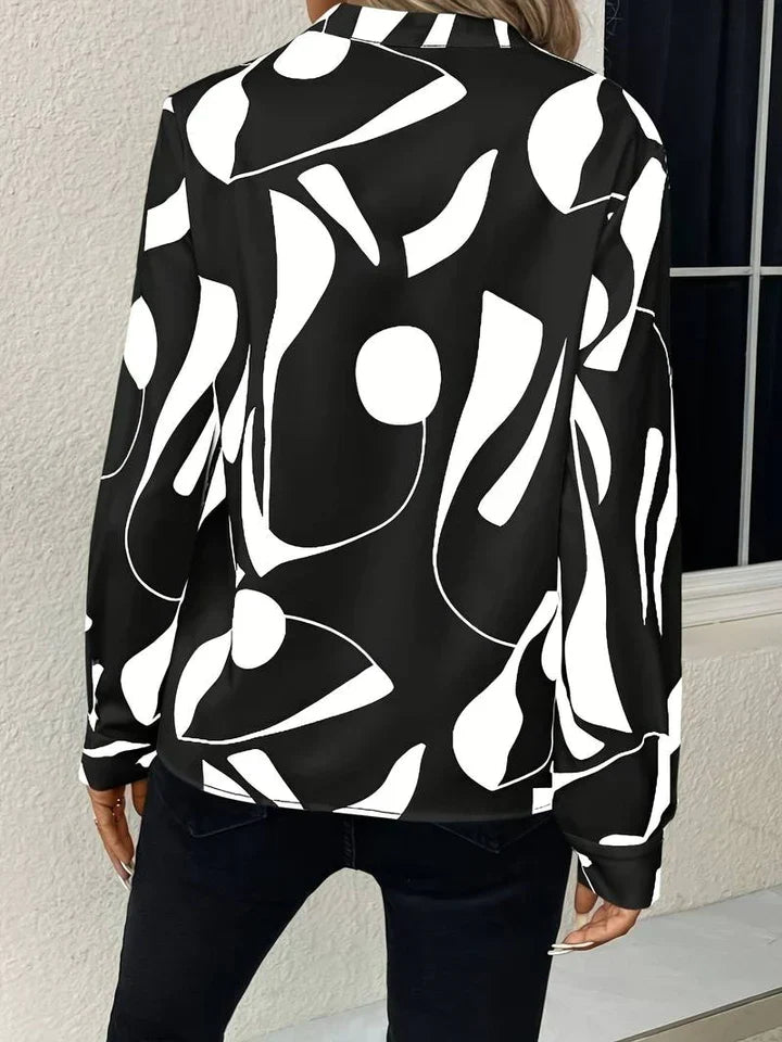 Elegante camicetta da donna con motivo astratto moderno e scollo a V