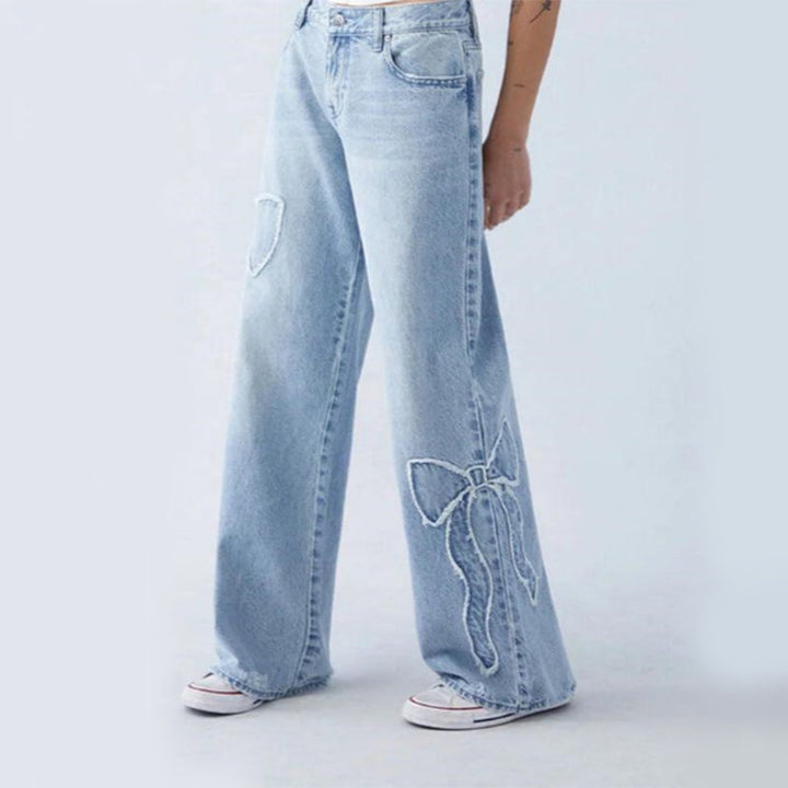 Wiga - pantalon en denim avec broderie de nœuds