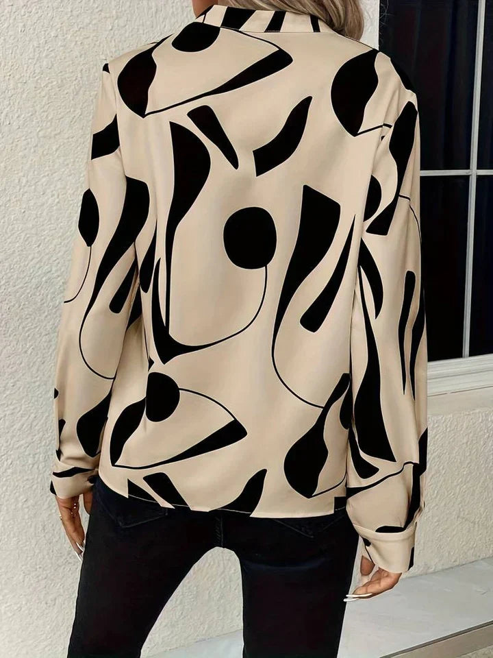 Elegante camicetta da donna con motivo astratto moderno e scollo a V